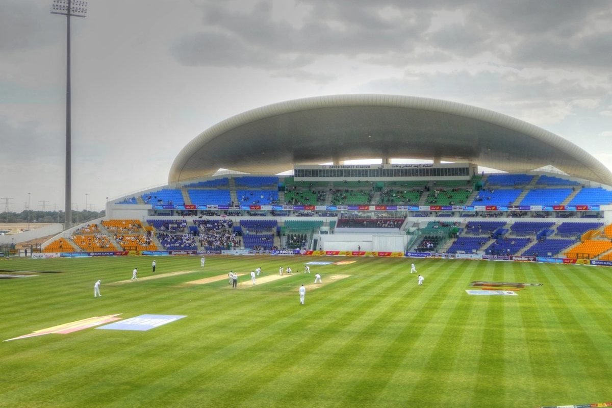 A cricket ground from the stands, play in progress.
