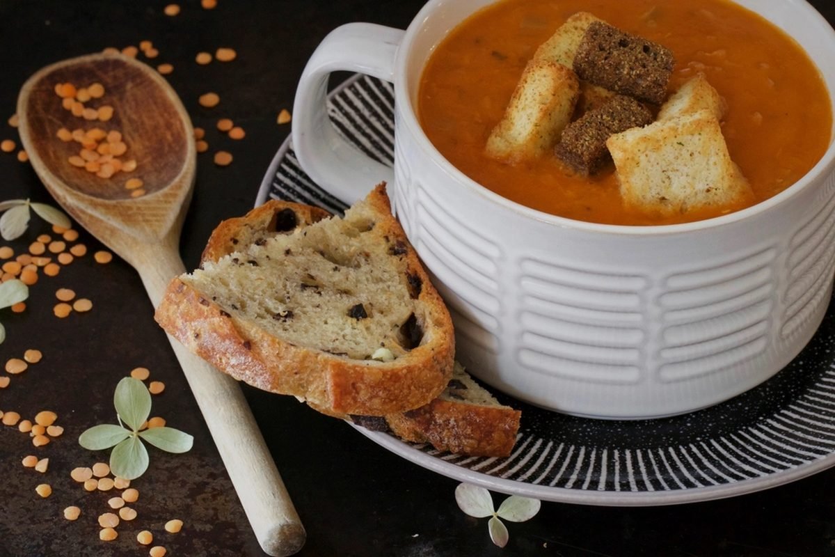 A bowl of lentil soup on a table.