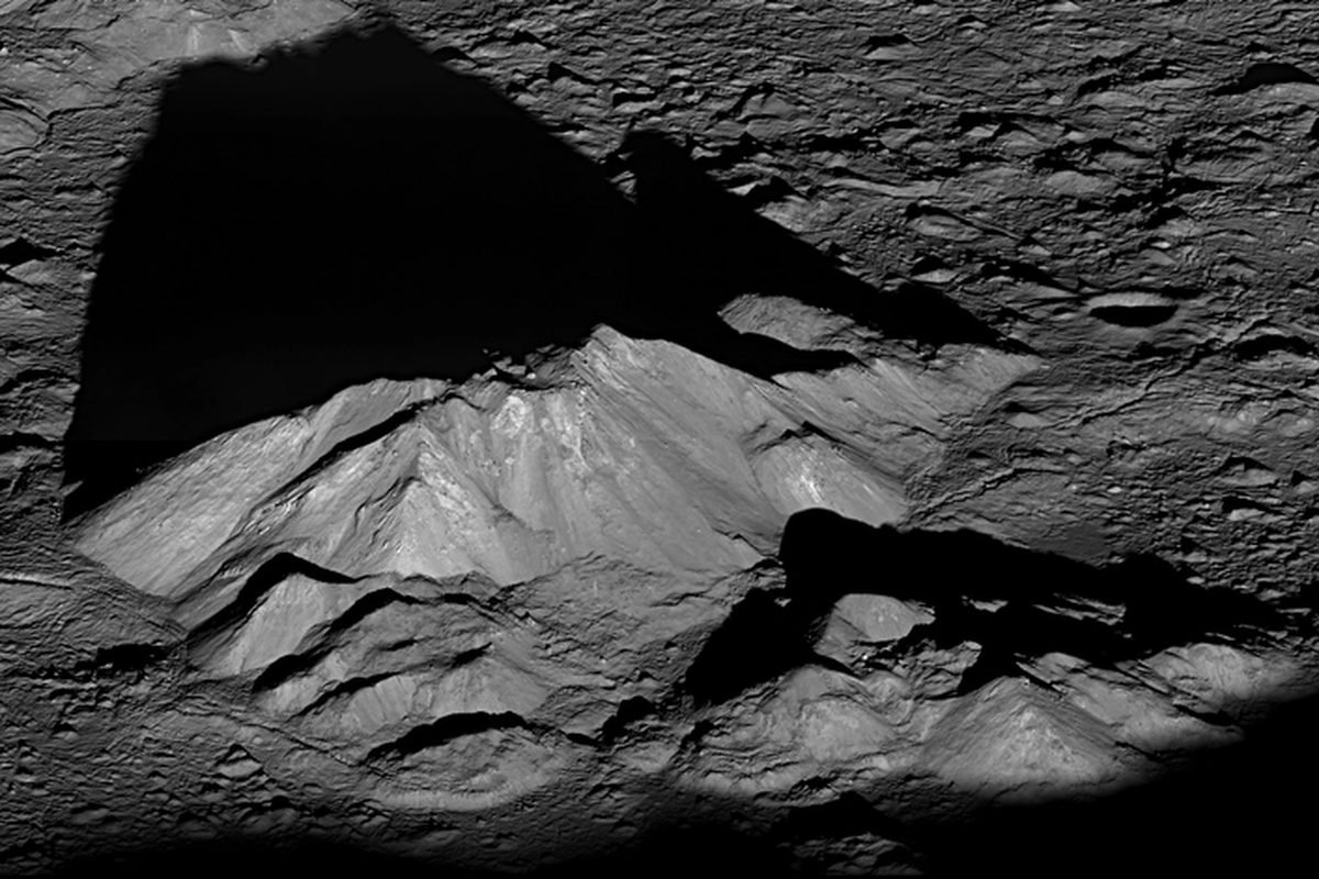 The cratered surface of the moon in raking sunlight.